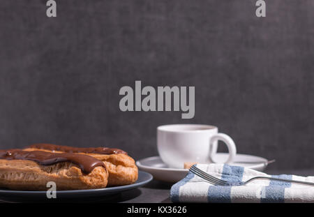 home backed eclairs with a cup of coffee Stock Photo