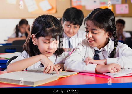 Indian School Kids Students Reading Book Studying In Classroom Stock Photo