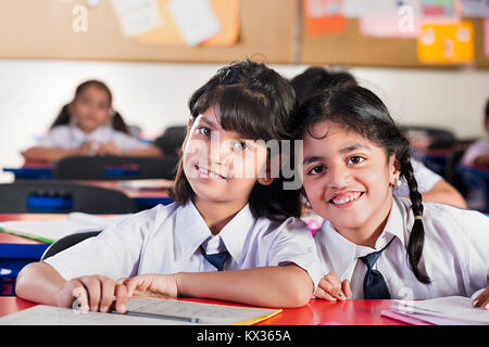 Indian School Kids Girls Students Reading Book Study In Classroom Stock Photo