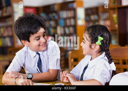 2 Indian School Kids Friend Students Book Studying In Library Stock Photo