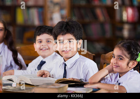 Indian School Kids Students Reading Book Study In Library Stock Photo