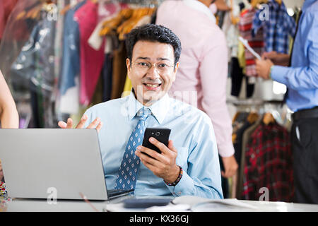 Surprised Business man Manager Reading Text-Message Cellphone Goodnews Boutique Store Stock Photo