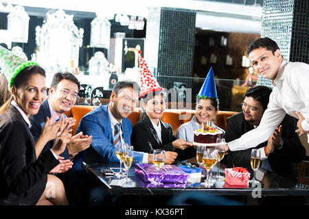 Group Business-People colleague Birthday Party celebration Waiter Giving cake Restaurant Stock Photo