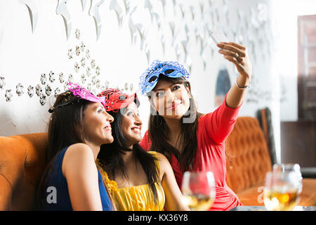 Three Ladies Friends Taking Selfie Photo Cellphone In-Restaurant New-Year Party Stock Photo