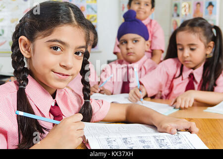 Indian School Childrens Students Notebook Writing Study In Class Stock Photo