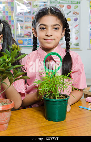 1 Indian School Kid Girl Student Magnifying Glass Checking Plant Stock Photo