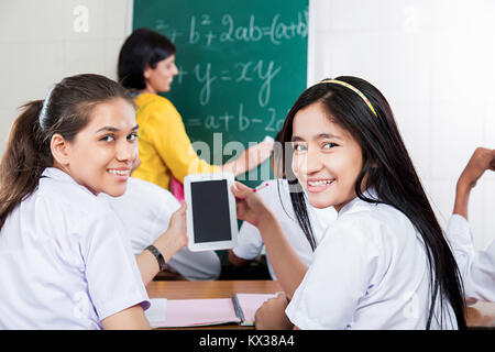 2 Indian School Girls Students Using Mobile Tablet Education Class Stock Photo