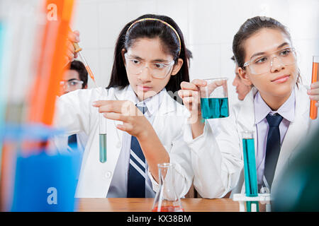 Indian High School Girls Students Doing Chemical Experiment Research laboratory Stock Photo