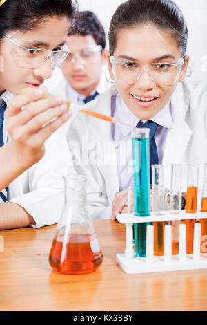 2 Indian School Girls Students Doing Experiment Chemical Liquid Lab Stock Photo