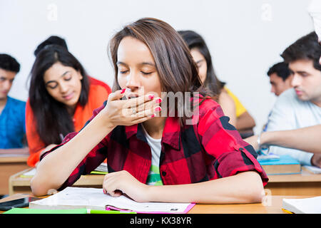 1 Indian College Teenager Girl Student Yawning Sleeping In Class Stock Photo