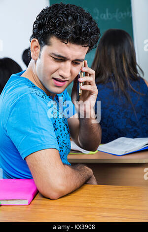 1 Indian College Young Boy Talking Cell Phone In Class Stock Photo