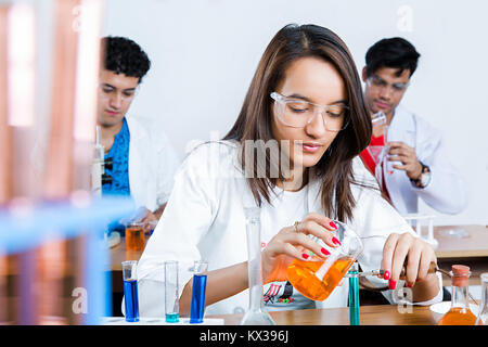 1 Indian College student pouring liquid Chemical Research Laboratory Discovery Stock Photo