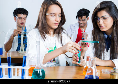 Indian Science Students Chemistry Lab Research Scientist pouring chemicals laboratory Stock Photo