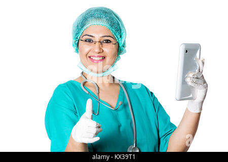 Indian Surgeon Doctor Using Mobile Tablet And Showing Thumbs Up Stock Photo