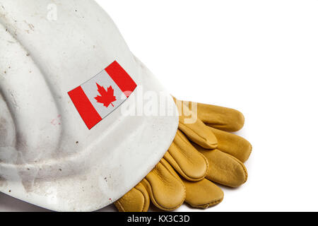 Construction Workers Hard Hat and Gloves showing badge of the  flag of Canada Stock Photo
