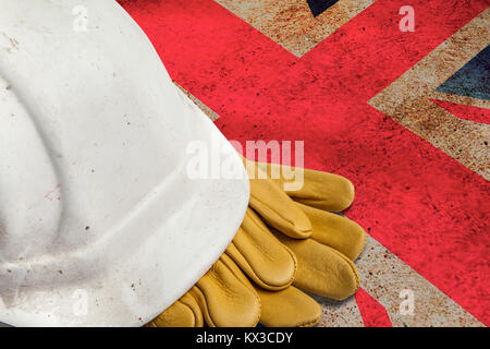Construction Workers Hard Hat and Gloves on flag of Great Britain Stock Photo