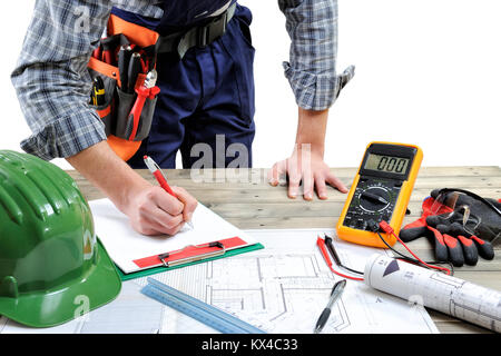 Electrician technician works on the project on an aged wooden desk, isolated on white background Stock Photo
