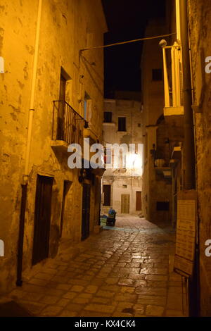 View of an empty alley at night inside the old city of Polignano a Mare, Apulia - Italy Stock Photo