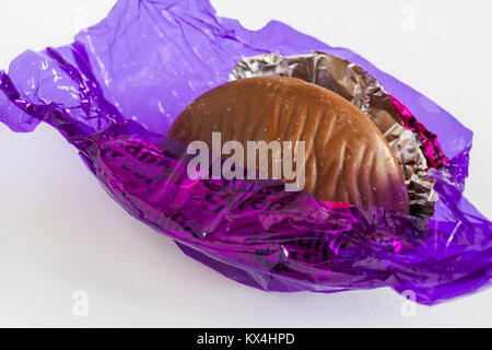 Quality Street chocolate by Nestle - the purple one, hazelnut and caramel in milk chocolate with wrapper undone Stock Photo