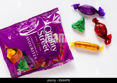 packet of Quality Street a selection of 4 favourites chocolates by Nestle - the purple one, the green triangle, toffee finger & strawberry delight Stock Photo