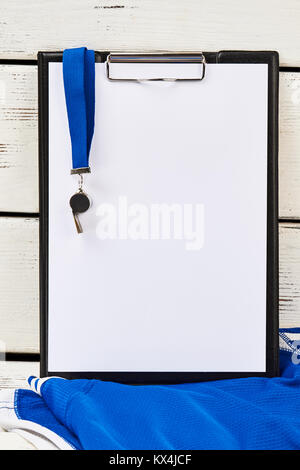 Trainer's uniform, clipboard and whistle Stock Photo
