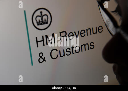 A woman looks at the HM Revenue and Customs, Gov.UK website on a computer Stock Photo