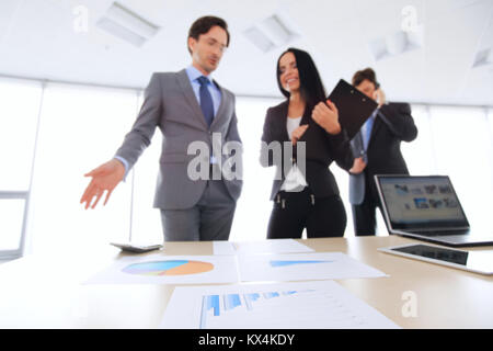 Business people discussing financial reports in office Stock Photo