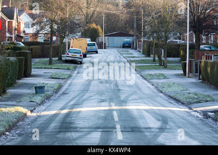 Cheshire. UK Weather.  Freezing temperatures overnight have left a sharp frost for many in the UK. A frozen road in Winsford, Cheshire today after an overnight severe frost Stock Photo