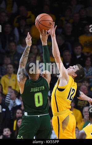 Wichita, Kansas, USA. 07th Jan, 2018. Wichita State Shockers guard Austin Reaves (12) gets a hand on a shot by South Florida Bulls guard Stephan Jiggetts (0) in the first half during the NCAA Basketball Game between the USF Bulls and the Wichita State Shockers at Charles Koch Arena in Wichita, Kansas. Kendall Shaw/CSM/Alamy Live News Stock Photo