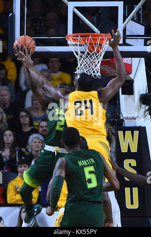 Wichita, Kansas, USA. 07th Jan, 2018. South Florida Bulls guard Terrence Samuel (2) drives to the basket and has his his shot blocked by Wichita State Shockers center Shaquille Morris (24) in the first half during the NCAA Basketball Game between the USF Bulls and the Wichita State Shockers at Charles Koch Arena in Wichita, Kansas. Kendall Shaw/CSM/Alamy Live News Stock Photo