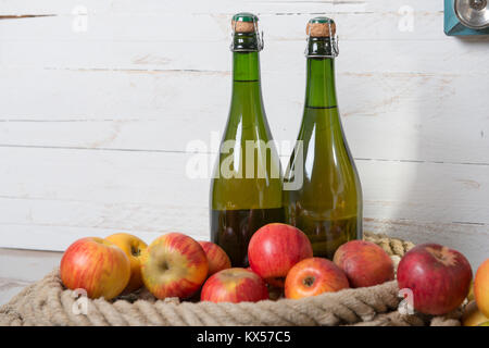 two bottles of cider and red apples of Normandy Stock Photo