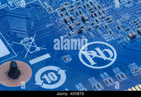 extreme close up of computer part with microcircuits in blue color and lead free symbol Stock Photo