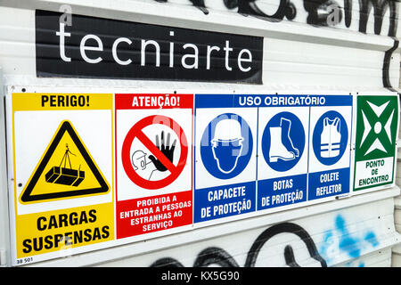 Lisbon Portugal,under new construction site building builder site,sign,worker protection,warning,danger,hard hat area,required safety apparel,reflecti Stock Photo