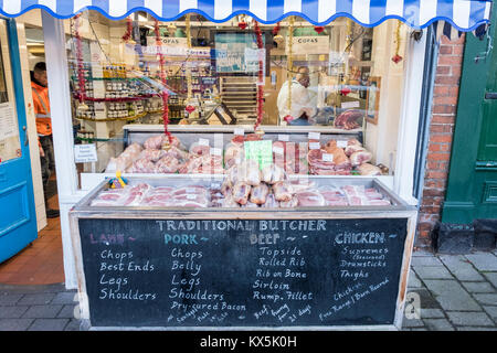 Traditional butcher's shop window display with fresh meat for sale on display. Hartley Wintney, Hart, Hampshire, England, GB, UK Stock Photo