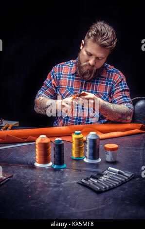 Professional Leather Worker makes quality products Stock Photo