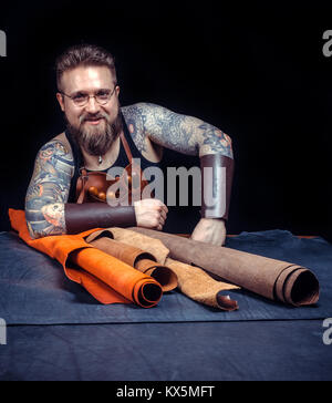 Leather Artisan producing leather workpiece Stock Photo