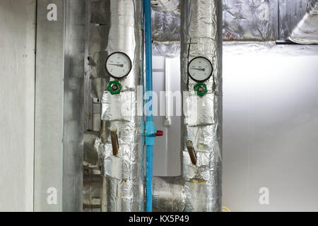 The pressure analog gage in water cold pipe on air condition system Stock Photo