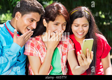 2 Indian Young Friend Sharing Reading Text Message Phone Garden Stock Photo