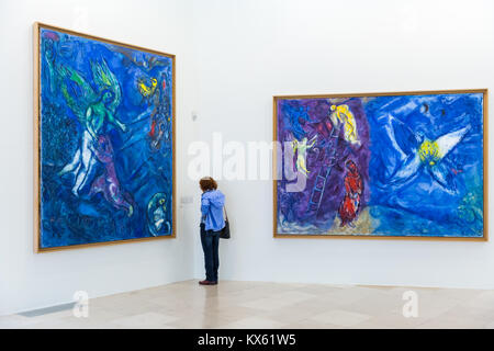 Woman looks at Marc Chagall bible paintings, Musée National Marc Chagall, Nice, France Stock Photo