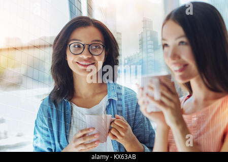 Cheerful smart woman having tea Stock Photo