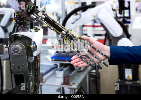 Cyber communication and robotic trend and artificial intelligence concepts. Industrial 4.0 Cyber Physical Systems concept. Robot and Engineerer human  Stock Photo