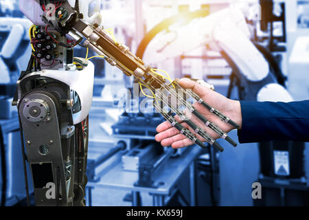 Cyber communication and robotic trend and artificial intelligence concepts. Industrial 4.0 Cyber Physical Systems concept. Robot and Engineerer human  Stock Photo