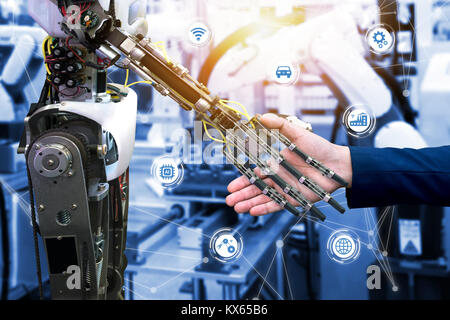 Cyber communication and robotic trend and artificial intelligence concepts. Industrial 4.0 Cyber Physical Systems concept. Robot and Engineerer human  Stock Photo