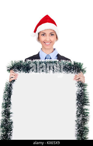 billboard woman in santa hat smiling,  beautiful happy model showing blank sign isolated on white background. Stock Photo