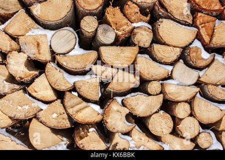 Detail of a stack of firewood (logs) covered in snow, Cortina D'Ampezzo, Italy Stock Photo