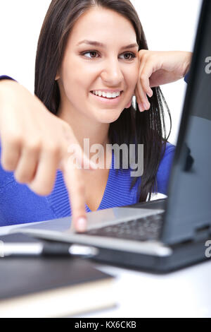 smiling girl pressing enter button on laptop, isolated on white background Stock Photo