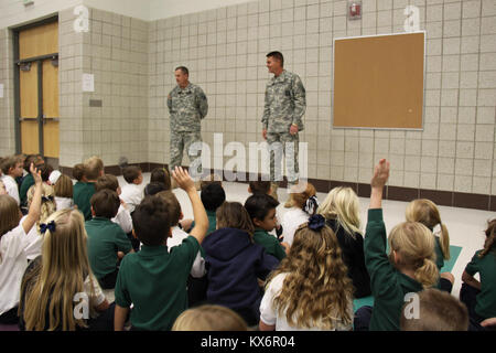 Major Gen. Jeff Burton and Command Sgt. Maj. Michael Miller thank the three kindergarten classes at St. John The Baptist Catholic Schools for their donation to the Utah Guard Charitable Trust. Stock Photo