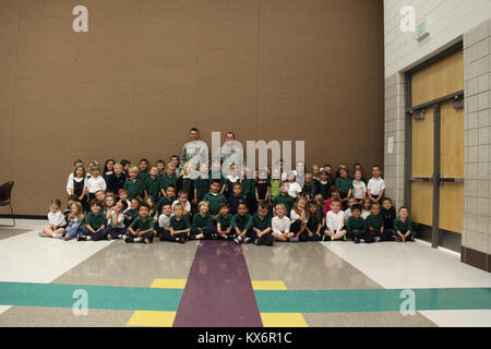 Major Gen. Jeff Burton and Command Sgt. Maj. Michael Miller thank the three kindergarten classes at St. John The Baptist Catholic Schools for their donation to the Utah Guard Charitable Trust. Stock Photo