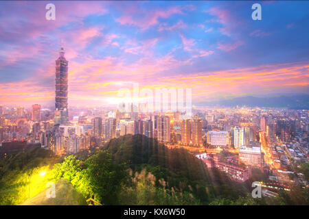 The Taipei 101 towers over the Xinyi District at twilight Stock Photo