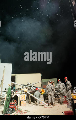 DENVER — Soldiers assigned to the Utah National Guard's Chemical, Biological, Radiological, and Nuclear Emergency Response Force Platform (CERFP) train on rescue techniques at the North Metro Fire Rescue Training Area below a cloud-and-bug-filled sky, during Colorado’s Vigilant Guard exercise, July 23 and into the early morning hours of July 24. Vigilant Guard is a multi-state, multi-agency exercise designed to build interagency coordination in preparation for emergencies and catastrophic events. (U.S. Army National Guard photo by Sgt. 1st Class Brock Jones, 128th Mobile Public Affairs Detachm Stock Photo